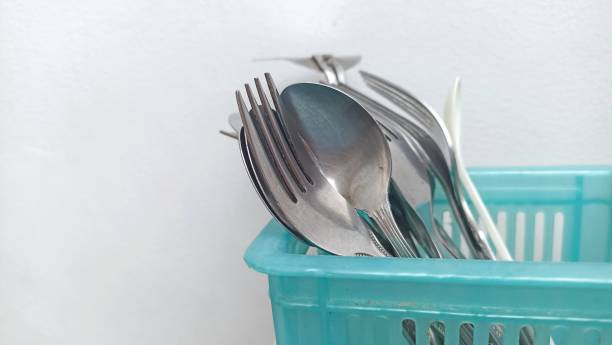 istock group of stainless steel spoons dan forks stored in a blue container. 1413785372