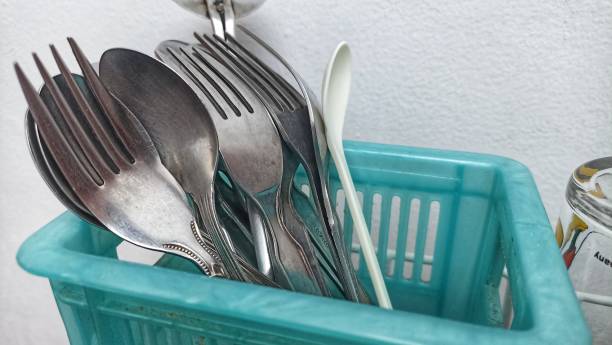 istock group of stainless steel spoons dan forks stored in a blue container. 1413785425