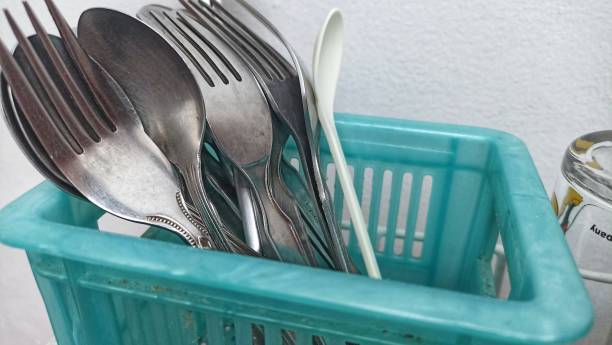 istock group of stainless steel spoons dan forks stored in a blue container. 1413785432