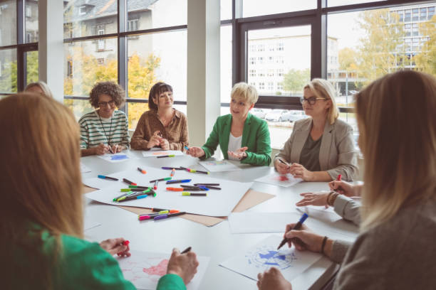 istock Businesswoman advising colleagues during activity 1413786763