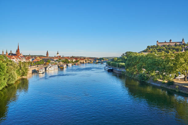 Wuerzburg, Germany - August 06, 2022: View of the banks of the Main in Würzburg. Marienberg Fortress on the right and the old city center on the left.