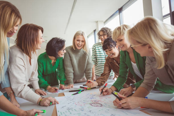 Happy colleagues doing team building activity Tilt image of business colleagues doing team building activity in office new idea office stock pictures, royalty-free photos & images
