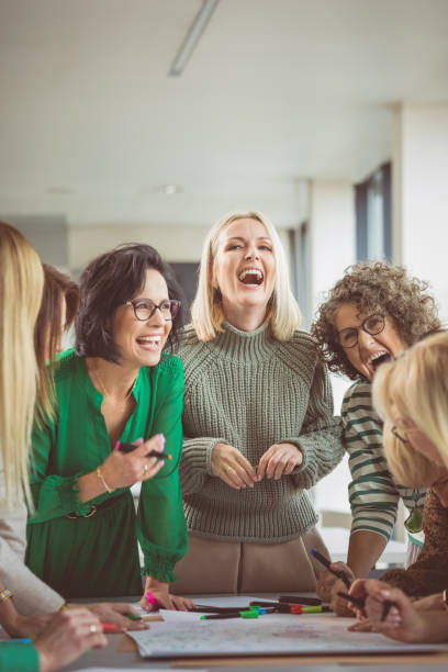 Happy female colleagues during meeting in office stock photo