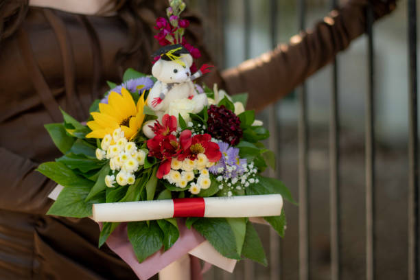 Colorful bouquet of flowers held by prom girl in brown dress