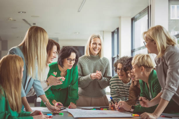 istock Smiling colleagues discussing together in meeting 1413794290