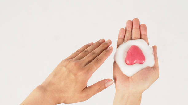 istock Hands washing with foaming and pink soap on white background. Studio shot 1413794941