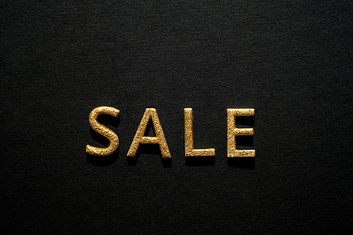 Sale - golden word on black. Online sale or clearance store concept.