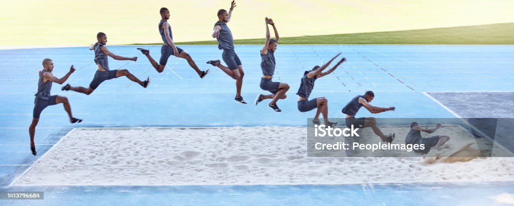 A sequence of a fit male athlete jumping in a sandpit competing in the long jump. Professional athlete or track racer during long or triple jump attempt is a competitive sports event or training Sequence of a young fit male athlete jumping in a sandpit competing in long jump. Professional athlete or track racer during long or triple jump attempt Long Jump Stock Photo
