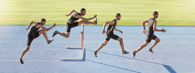Sequence of a male athlete jumping over a hurdle. Professional sprinter or track racer during obstacle race
