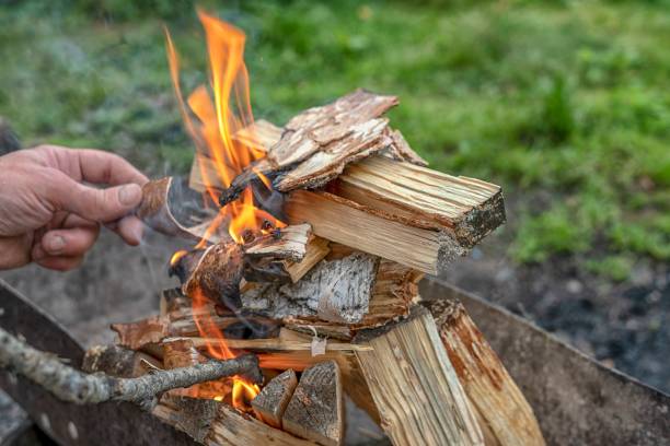 istock Male hand starts fire for bbq 1413796705