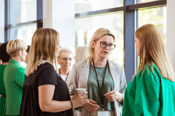 istock Blond female manager discussing with colleagues 1413798372