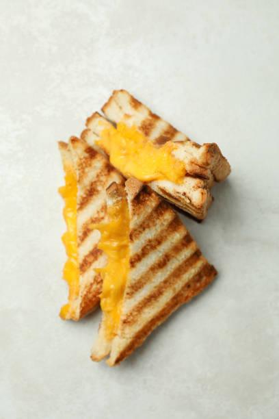 istock Grilled sandwiches on white textured background, top view 1413798495