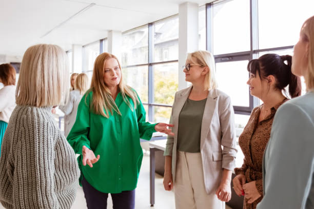 Colleagues discussing with managers in office stock photo