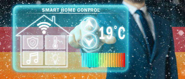 Frozen citizen of Germany adjusting heating temperature on a virtual screen of smart home controller, winter blizzard background. Concept of forced thrift because increased price for heating home. ciudadano congelado de alemania ajustando la temperatura de la calefacción en una pantalla virtual de controlador doméstico inteligente, fondo de ventisca de invierno. concepto de ahorro forzado porque aumento del precio de la calefacción del hogar