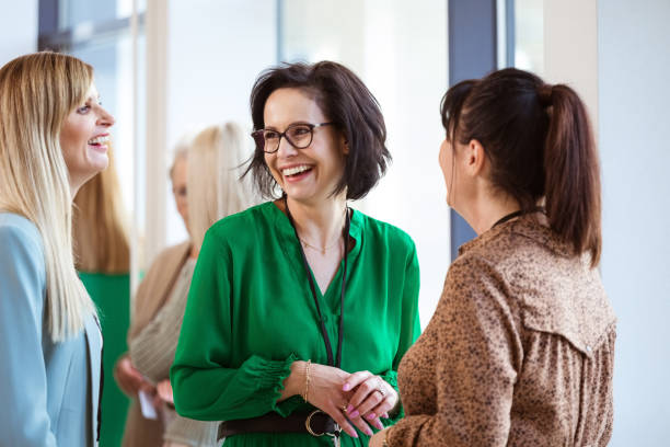 istock Happy female colleagues at event in office 1413800563