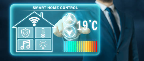 istock Man adjusting heating temperature on a virtual screen of smart home controller, dark background 1413800570