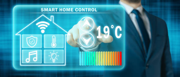 istock Man adjusting heating temperature on a virtual screen of smart home controller, futuristic background 1413800572