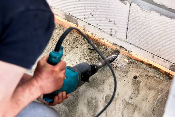istock An electric rock drill at construction site is used to drill hole in wall. 1413801560