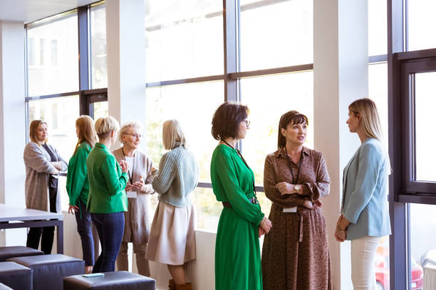 istock Mature business professionals discussing at event 1413801739