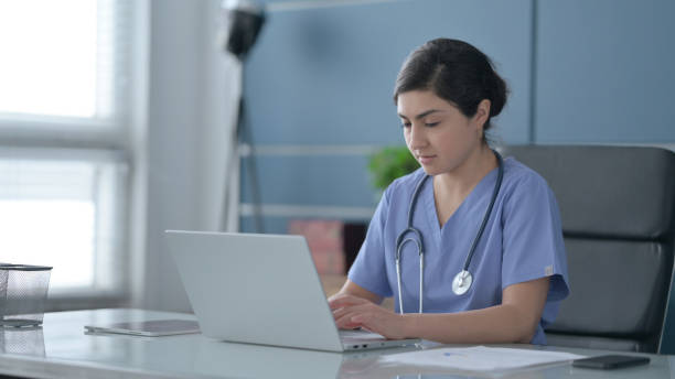 istock Indian Female Doctor Working on Laptop in Office 1413801811