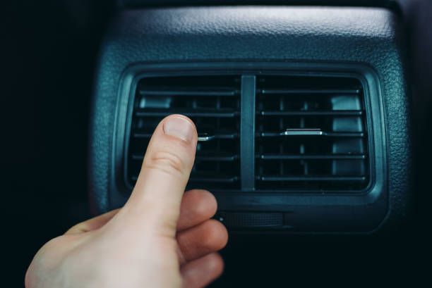 istock Man adjusting air conditioner inside the car. 1413801978