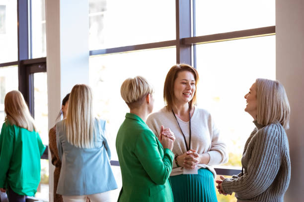 istock Mature businesswomen discussing at networking event 1413802107