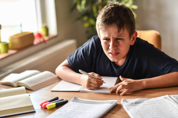 istock Male Child Getting Closer To See Blackboard Due To Myopia Related Problems 1413802608