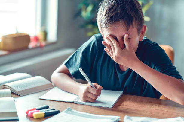 istock Eye Rubbing To Eliminate Sore Eyes After Trying To Write Homework With Myopia By Child 1413802718