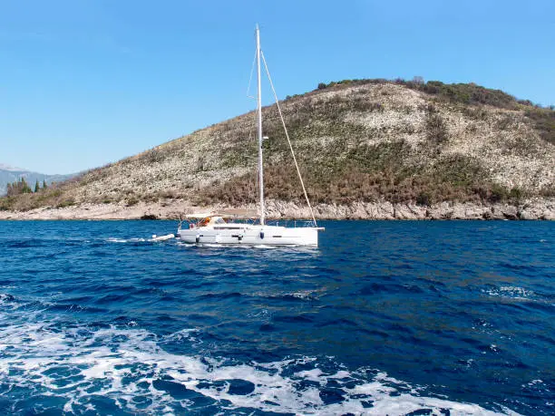 Beautiful view of the pleasure yacht in the bay with mountains in the background