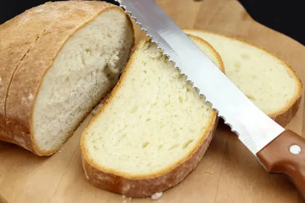 Seed bread, homemade bread,cutting bread. Cut fresh bread with a knife