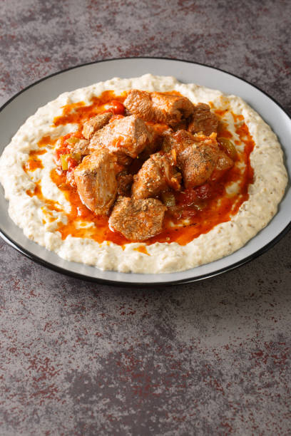 Hunkar Begendi Meat Stew over Eggplant Sauce closeup in the plate. Vertical Hunkar Begendi Meat Stew over Eggplant Sauce closeup in the plate on the table. Vertical hunkar begendi stock pictures, royalty-free photos & images
