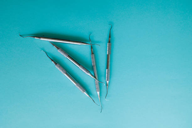 istock Periodontal scalers on the light blue background 1413807468