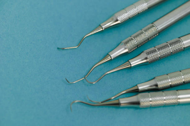 istock Steel dental instruments on a blue background 1413807478