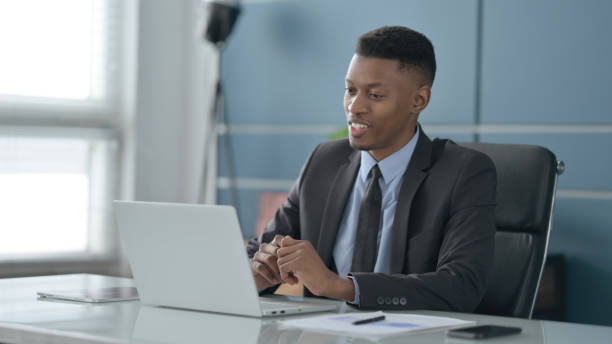 istock African Businessman Talking on Video Call on Laptop in Office 1413808626