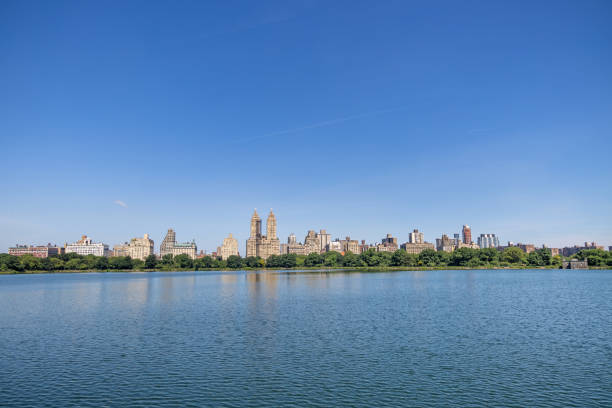 Central Park, Manhattan, New York, NY, USA - June 30, 2022: View across the Jacqueline Kennedy Onassis Reservoir to the skyline of western Manhattan