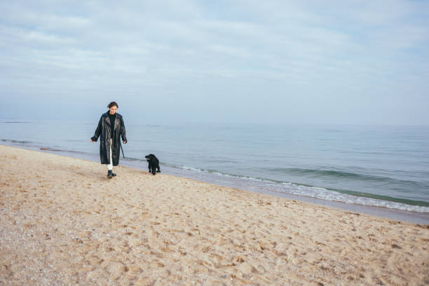 istock Happy young woman wearing black coat 1413813332