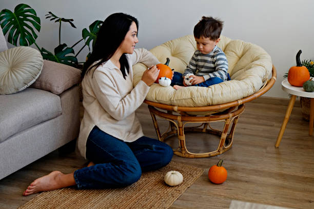 istock Mom and son making halloween decoration. 1413817230