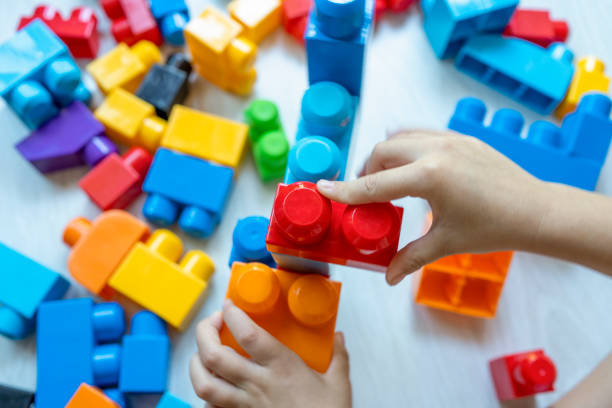istock Child playing with colorful toy blocks. 1413818070