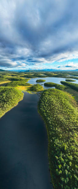 istock Sunset over lakes surrounded by green forest 1413818345