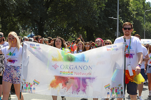 Brighton, England - August 6th 2022: Organon Pride Network at the Brighton & Hove Pride parade.\nOne of the UK's most significant pride events is celebrating its 30th anniversary. Brighton & Hove Pride is intended to celebrate, and promote respect for, diversity and inclusion within the local community and support local charities and causes through fundraising.