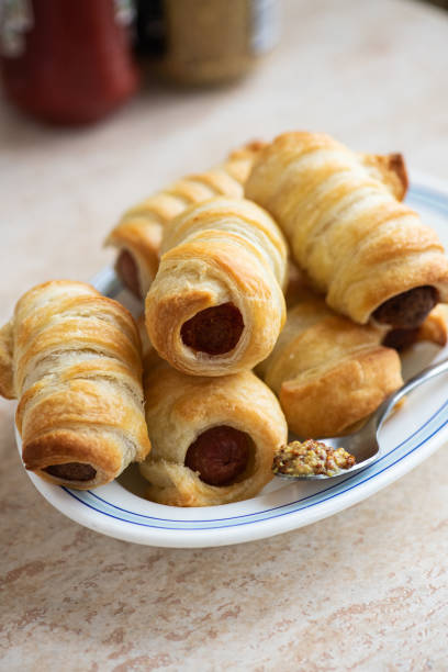 istock Pigs in a blanket - mini sausage roll on a plate. 1413819229