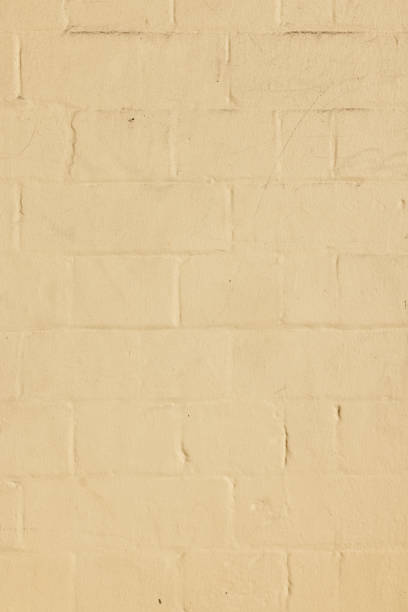 Part of an old cream colored brick wall
