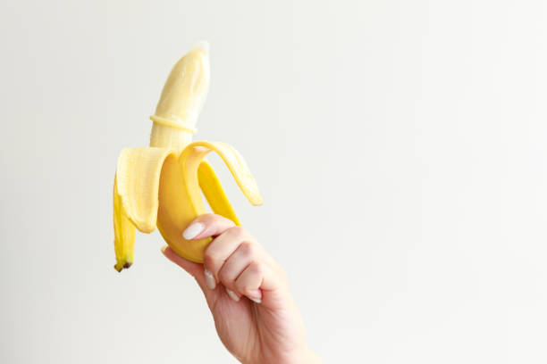 istock banana with a condom on a white background. contraceptives. 1413821335