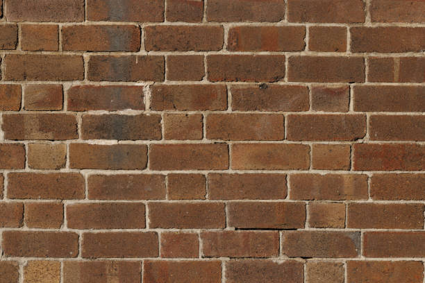 Old Brown brick wall Section of an old brown brick wall. brown bricks stock pictures, royalty-free photos & images