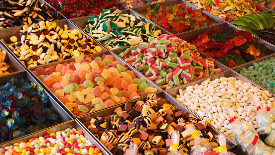 Close up view of stand of colorful candies. Unhealthy food concept.