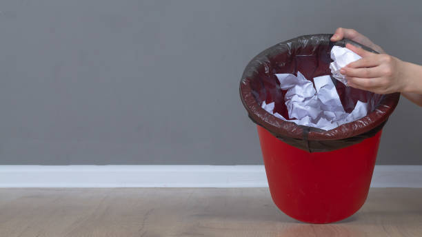 istock Throw crumpled paper in a red trash can 1413821764