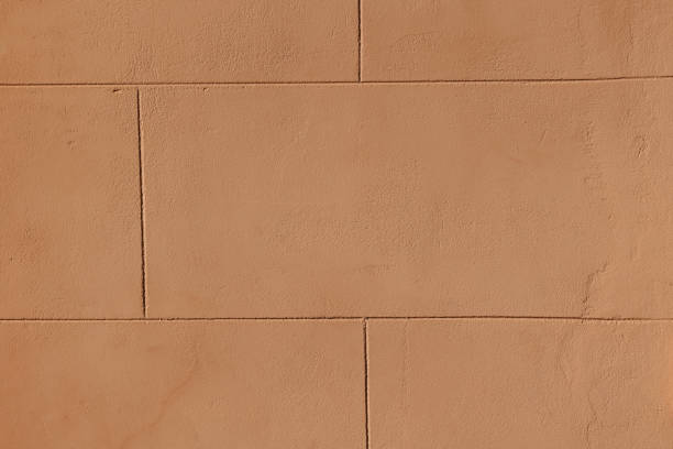 Plaster rough texture of wall, color of very tanned skin or burnt paper or parchment. Abstract background, idea for graphic design or banner