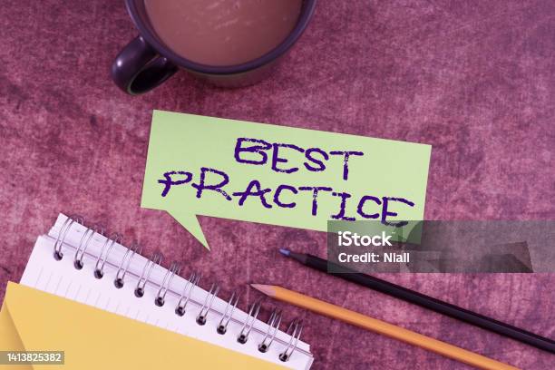 Text Caption Presenting Best Practice Word For Method Systematic Touchstone Guidelines Framework Ethic Speech Bubble With Spiral Book And Coffee Showing New Ideas For Business Stock Photo - Download Image Now