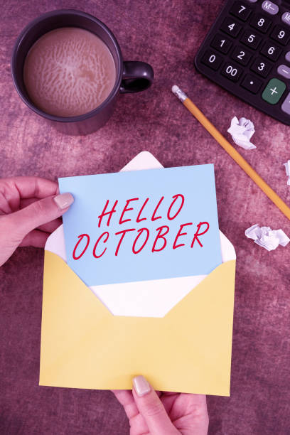 istock Writing displaying text Hello October. Business showcase Last Quarter Tenth Month 30days Season Greeting Woman Holding Blank Letter With Coffee And Stationery Over Wood. 1413825415
