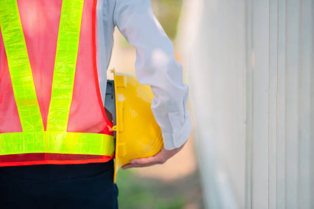 istock Engineer holding hard hat construction worker professional safety work industry building person manager service 1413826515